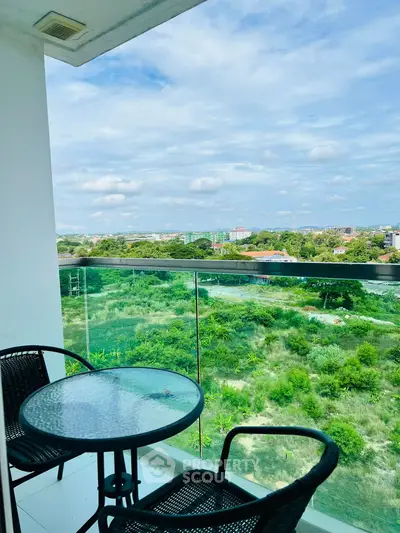Stunning balcony view with lush greenery and cityscape, perfect for relaxation and outdoor dining.