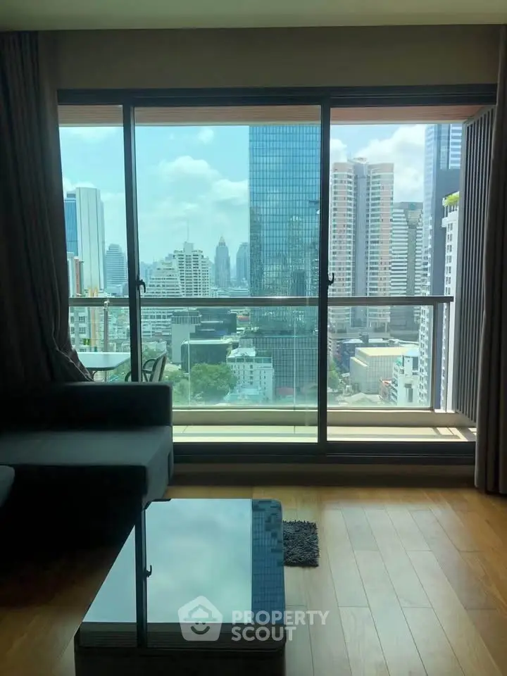 Stunning city view from modern living room with floor-to-ceiling windows and sleek wooden flooring.