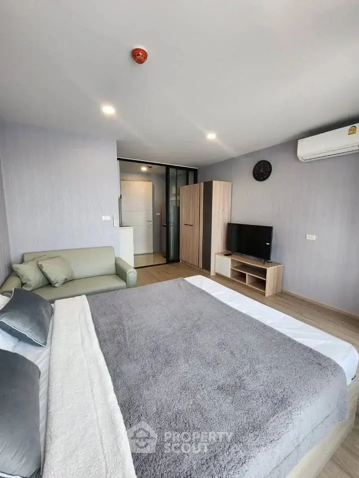 Modern bedroom with cozy decor and stylish furniture in a contemporary apartment.