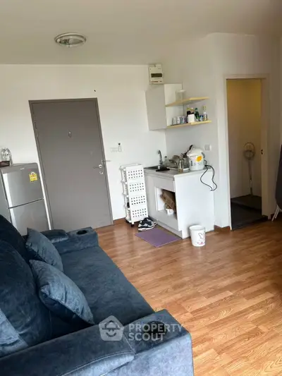 Cozy living room with compact kitchen in modern apartment