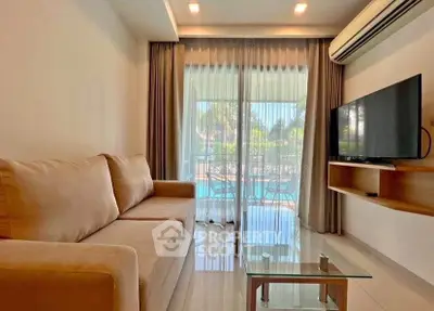 Modern living room with pool view, featuring a cozy sofa and wall-mounted TV, perfect for relaxation.