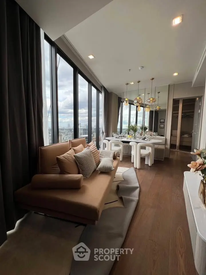 Luxurious high-rise living room with panoramic city views and elegant dining area.