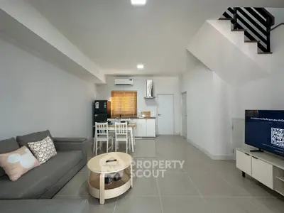 Modern open-plan living room with sleek kitchen and stylish decor