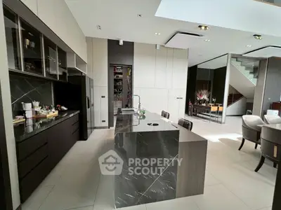 Luxurious modern kitchen with sleek marble island and open layout, perfect for entertaining.