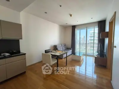 Modern living room with open kitchen and city view balcony in high-rise apartment
