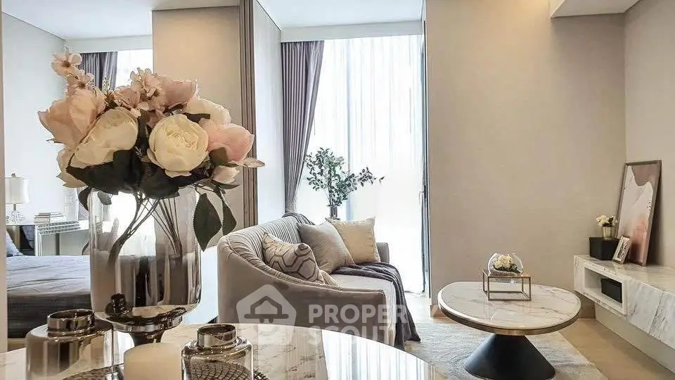 Luxurious living room with elegant decor and natural light, featuring a cozy sofa and stylish marble table.