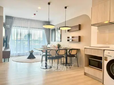 Modern open-plan living room with dining area and natural light