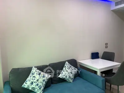 Modern living room with stylish sofa and dining area, perfect for cozy gatherings.