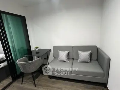 Modern living room with sleek gray sofa and stylish glass table