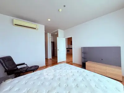 Spacious bedroom with modern furnishings and ample natural light