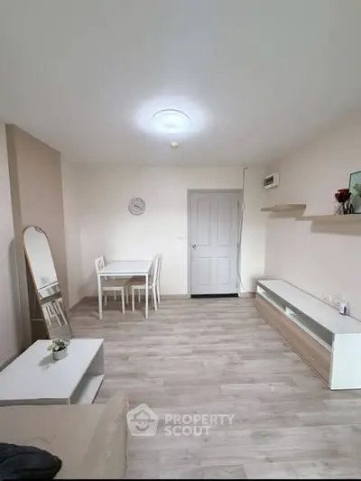 Bright and modern living room with stylish furniture and wooden flooring.