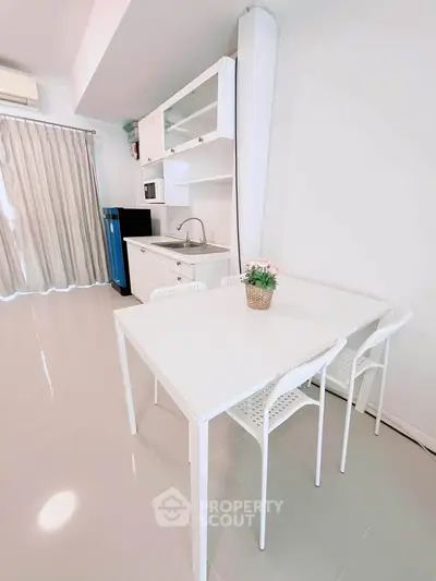 Modern kitchen with sleek white dining set and compact layout