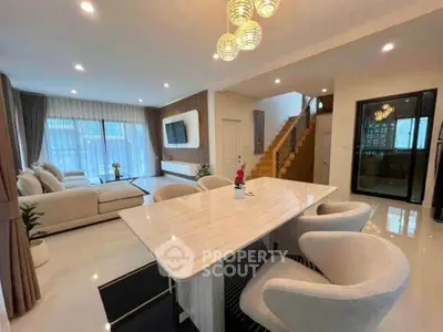 Spacious modern living room with elegant dining area and stylish staircase