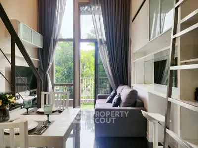 Modern living room with high ceiling and large windows overlooking lush greenery.