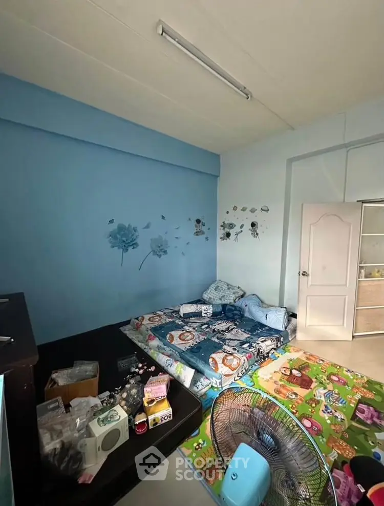 Cozy bedroom with playful decor and vibrant wall art, perfect for a child's retreat.