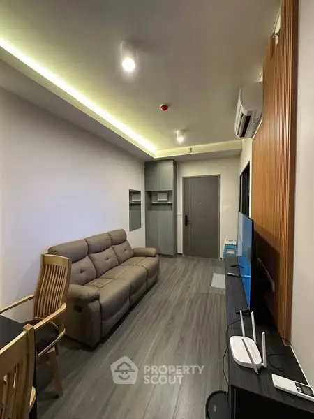 Modern living room with sleek furniture and ambient lighting, perfect for cozy evenings.