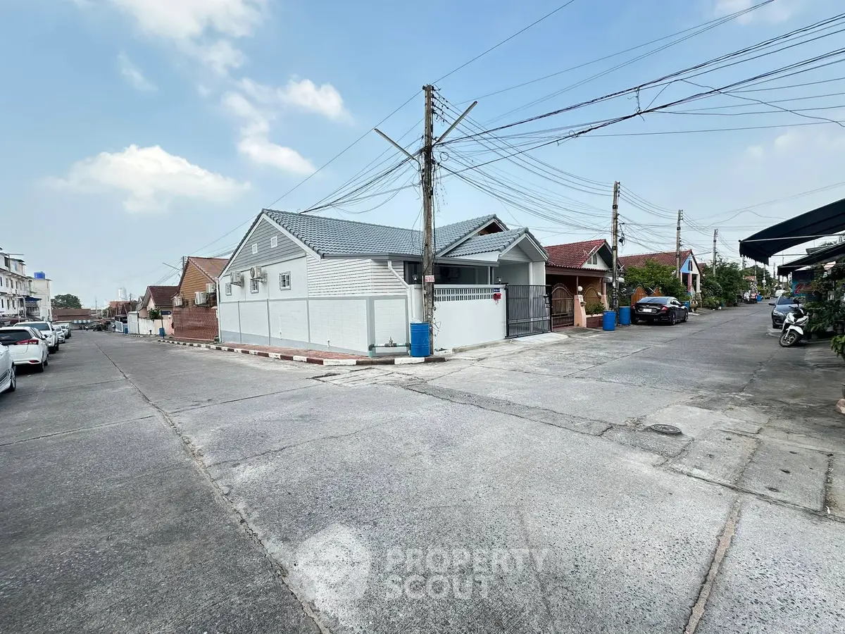 Charming residential street view with modern houses and clear blue sky.