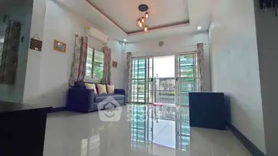 Spacious living room with modern lighting and large windows for natural light.