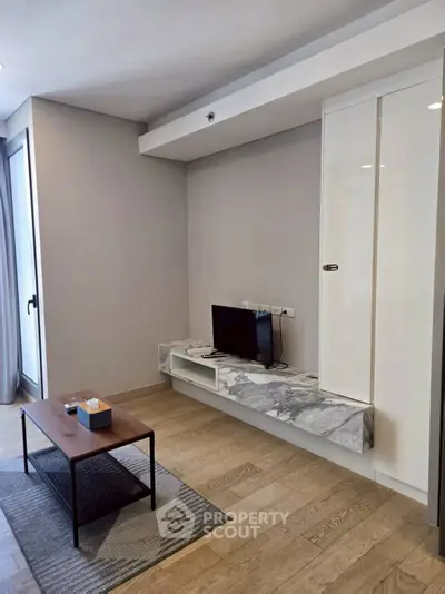 Modern living room with sleek TV setup and stylish coffee table