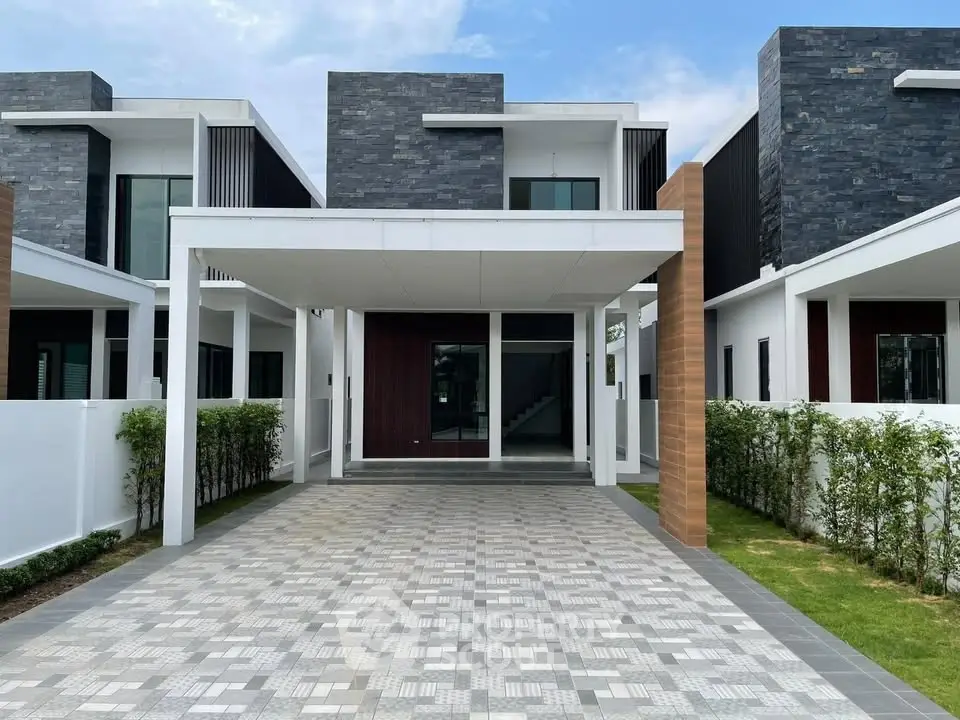 Modern two-story house with sleek design and spacious driveway in a serene neighborhood.