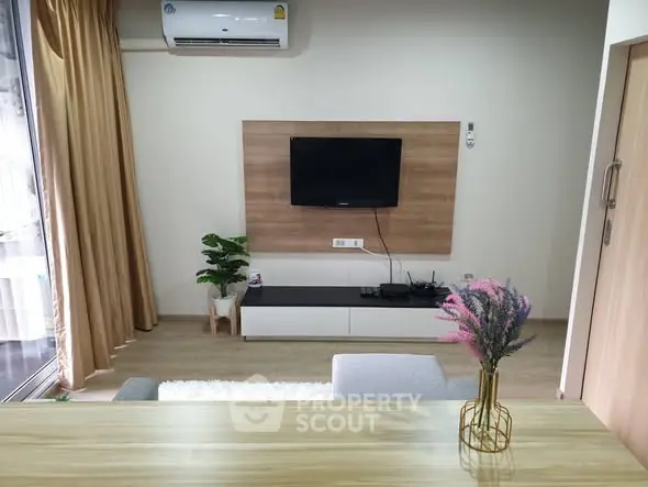 Modern living room with wall-mounted TV and stylish decor