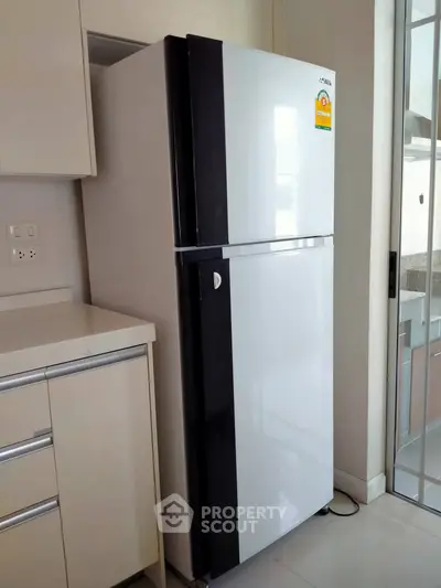 Modern kitchen with sleek refrigerator and stylish cabinetry