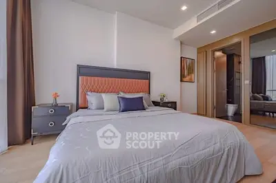 Modern bedroom with stylish decor and ensuite bathroom in luxury apartment