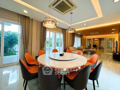 Luxurious open-plan living and dining area with modern lighting and stylish furniture.