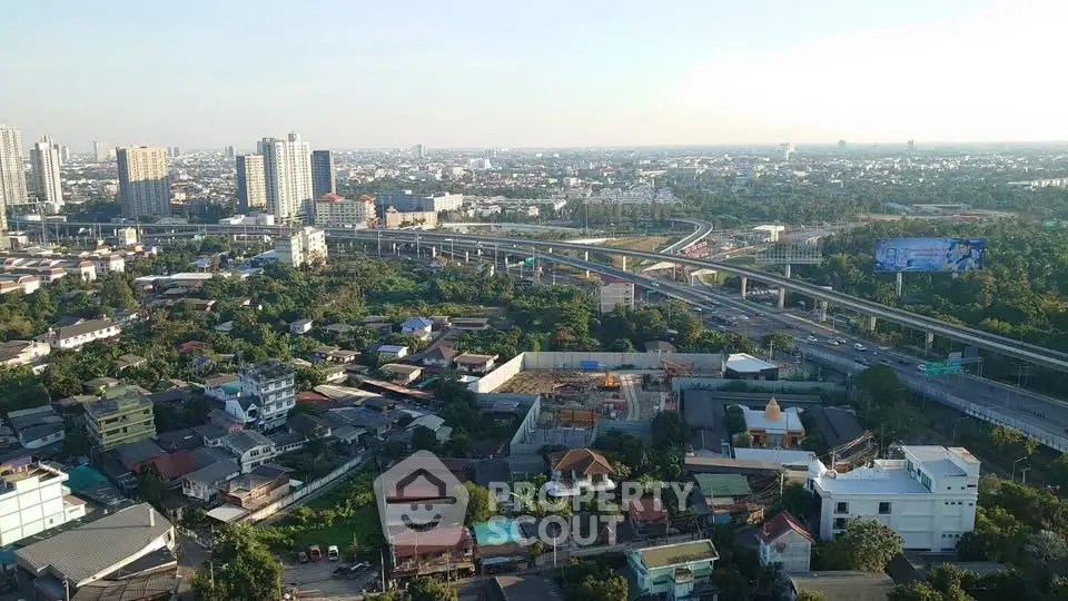 Stunning aerial view of urban landscape with high-rise buildings and lush greenery, perfect for real estate investment.