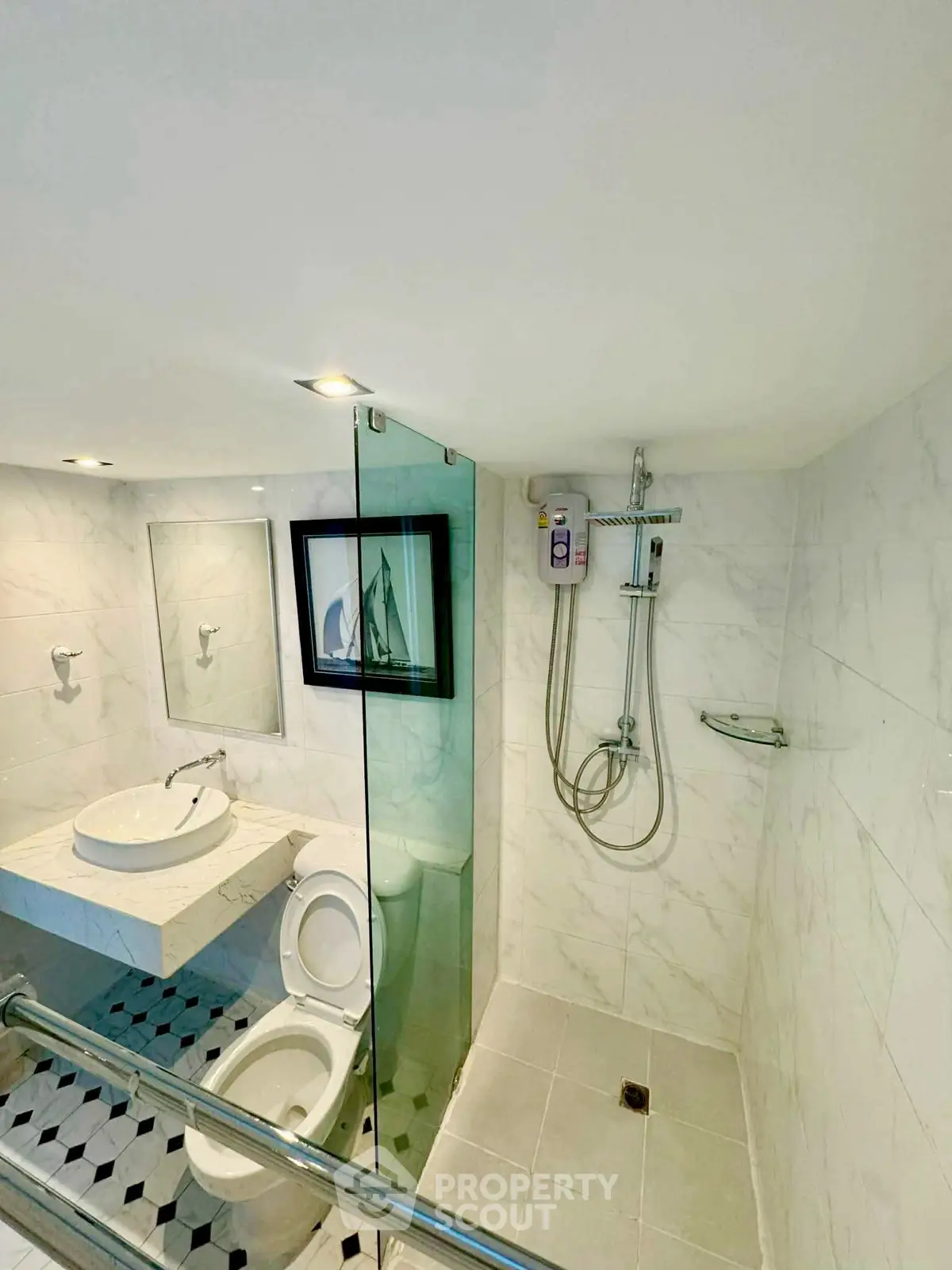 Modern bathroom with glass shower and elegant fixtures in a stylish home.