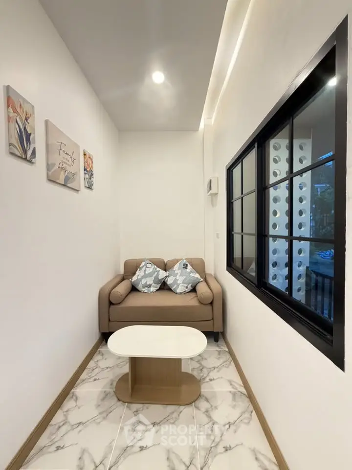 Cozy small living area with modern decor and comfortable seating