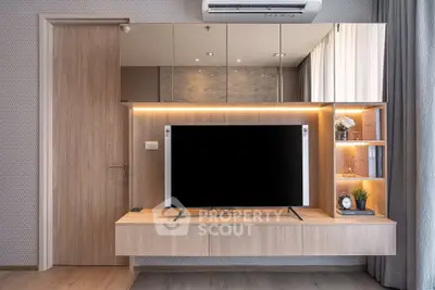 Modern living room with sleek wooden TV unit and mirrored wall design