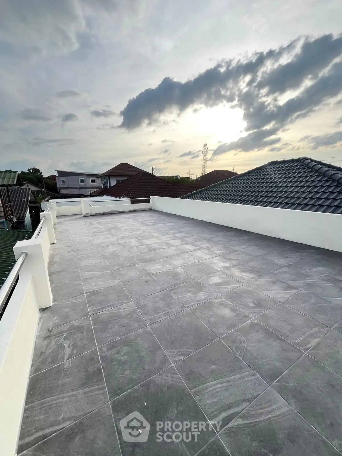 Spacious rooftop terrace with panoramic views and modern tiling, perfect for outdoor relaxation and entertainment.
