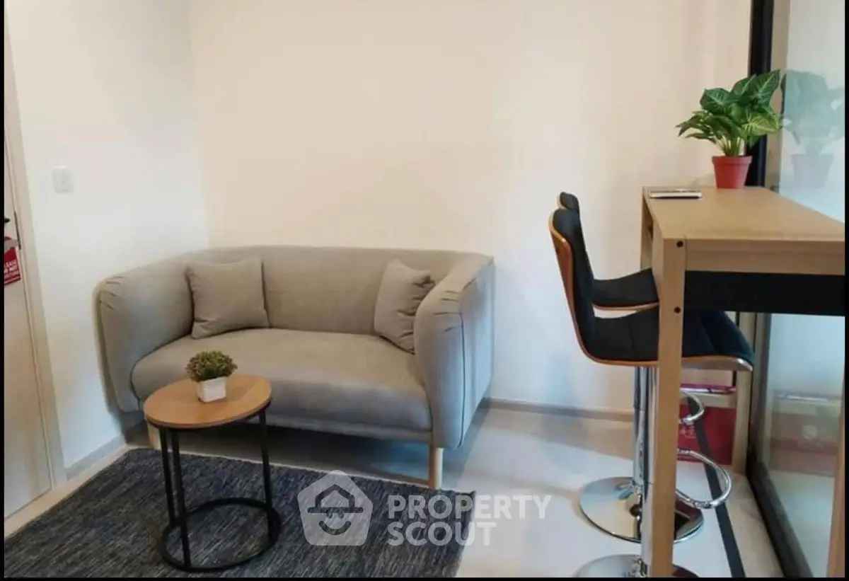 Cozy living room with modern sofa and bar-style seating, perfect for relaxation and entertaining.
