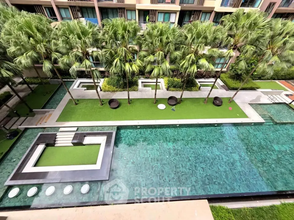 Luxurious apartment complex with stunning pool and lush garden view