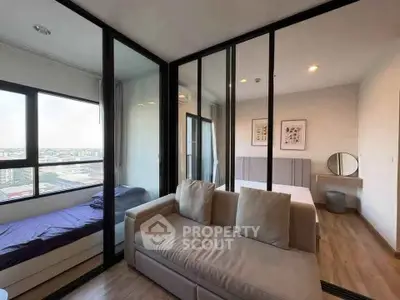 Modern apartment with glass partition, cozy living area, and city view, ideal for urban living.