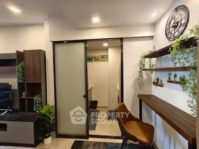 Modern living room with stylish decor and sliding door to bathroom