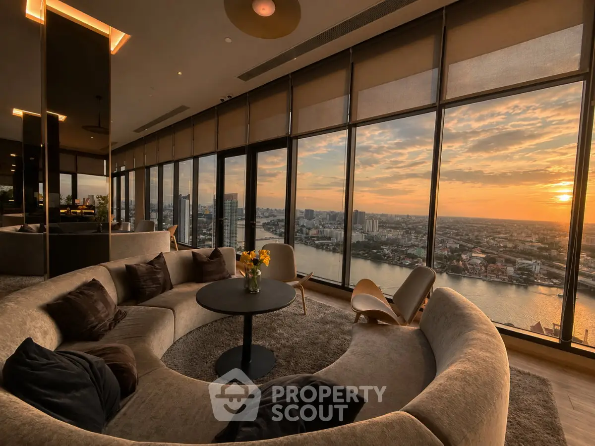Luxurious living room with panoramic city view and modern circular sofa at sunset.