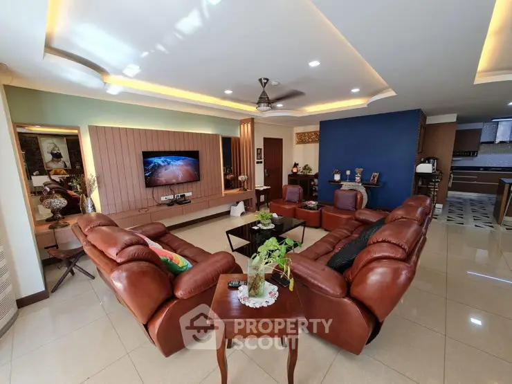 Luxurious living room with leather sofas and modern decor, perfect for relaxation and entertainment.