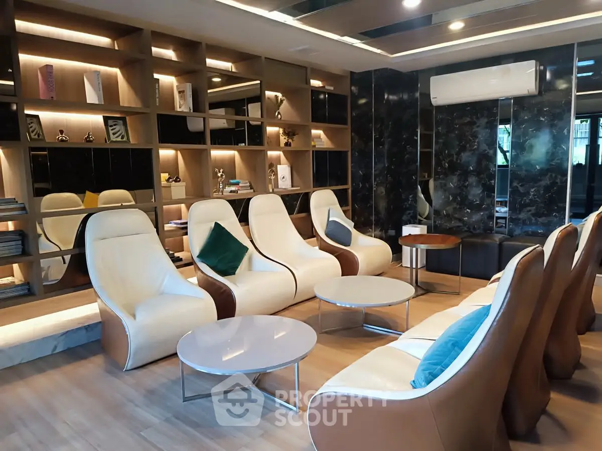 Luxurious modern living room with elegant seating and stylish shelving, perfect for relaxation and entertainment.