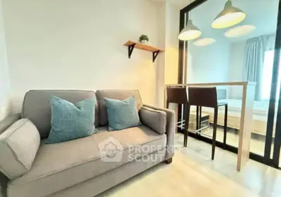 Modern living room with cozy sofa and stylish bar seating in a bright apartment.