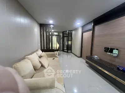 Spacious modern living room with elegant decor and comfortable seating in a stylish apartment.
