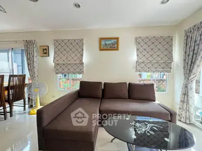 Charming living room with cozy brown sofa and elegant decor, perfect for relaxation.