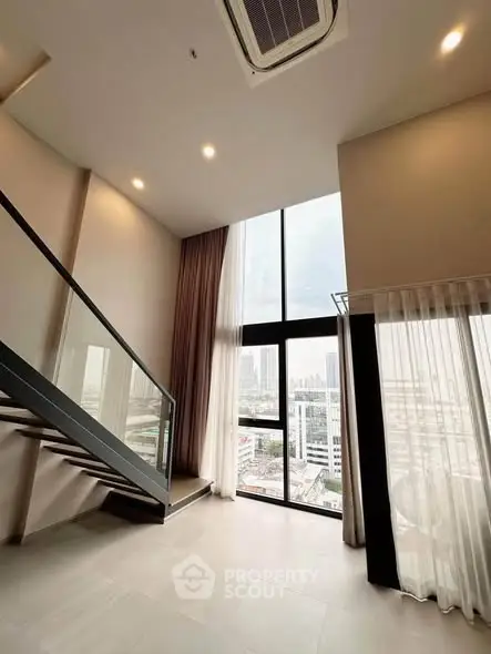 Stunning high-ceiling living room with floor-to-ceiling windows and city view