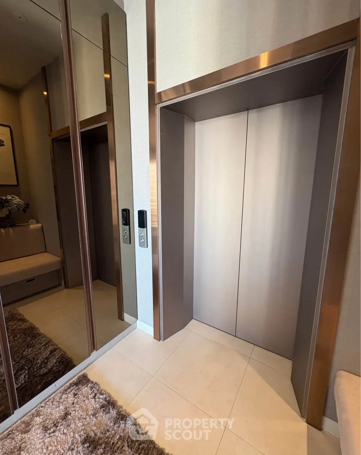Luxurious modern elevator with sleek design and mirrored walls in upscale building.
