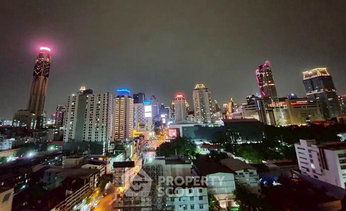 Stunning nighttime cityscape view of illuminated skyscrapers and vibrant urban life.