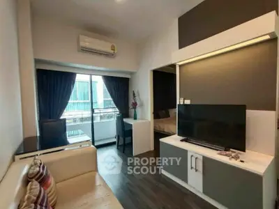 Modern living room with balcony view, sleek furniture, and stylish decor in a contemporary apartment.