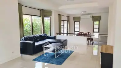 Spacious living room with modern furniture and large windows offering natural light.