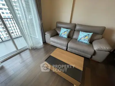 Modern living room with cozy sofa and balcony view in urban apartment