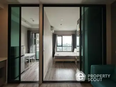 Modern apartment interior with sliding glass doors and city view